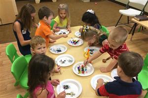 Group of young children at a table painting