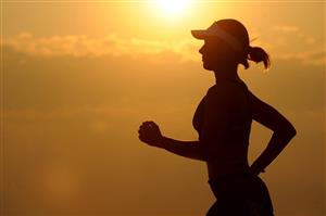Woman running at sunset